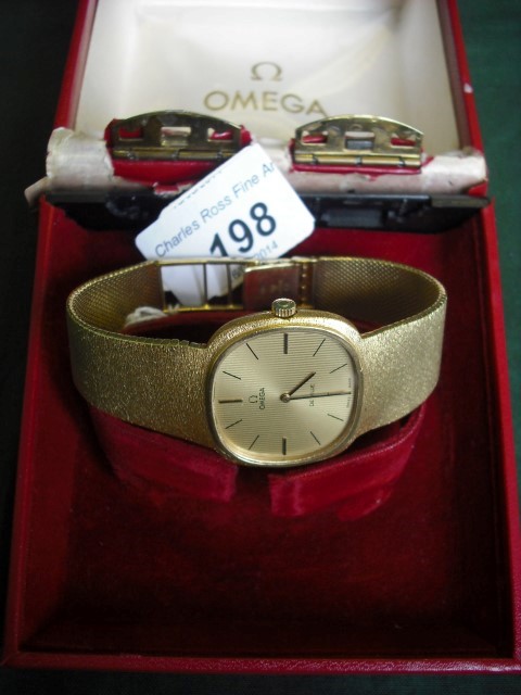 An 18 carat gold Omega De Ville wristwatch on a mesh link bracelet, stamped 750 with import marks.