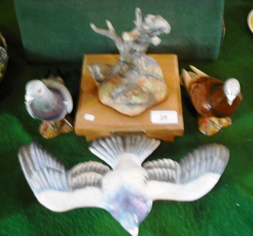 A Mistan ceramic model of a racing pigeon, standing on a plinth titled First Home, together with two