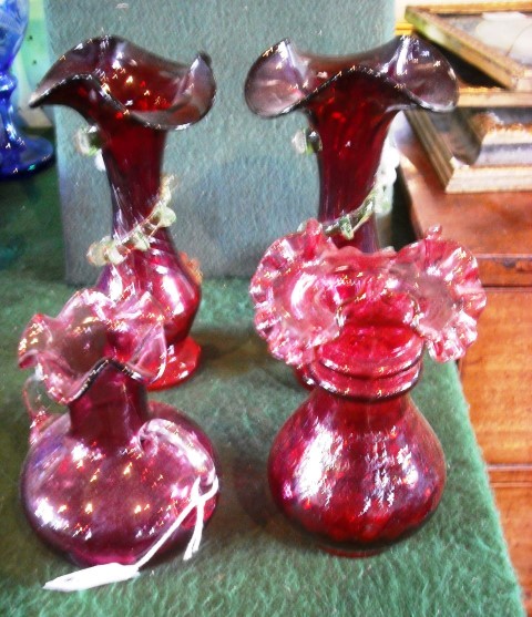 A collection of four Victorian and later cranberry glass vases, to include one matching pair, 12