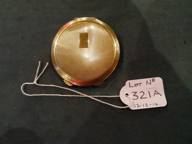 A 9 carat gold lady's compact, with engine turned decorated case, enclosing a mirror lined interior,