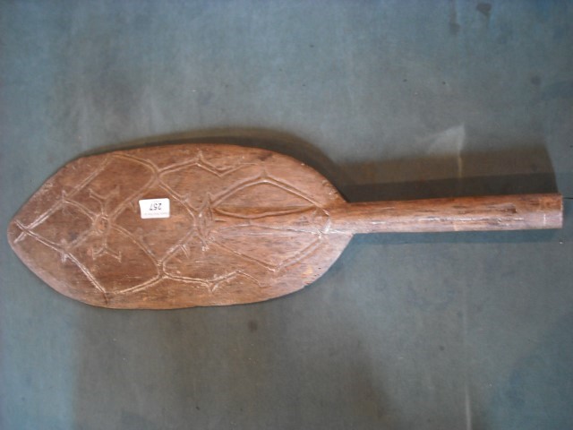 A decorative Maori paddle, carved on one side with a geometric design, 68.5cm.