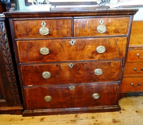 A 19th century mahogany chest, having plain top over two short and three long flame veneered