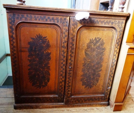 A Victorian pine cupboard, the rectangular top over a pair of stencil decorated panelled doors,