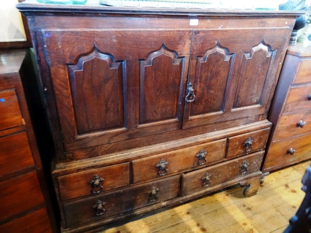 A late 18th century oak cupboard of pegged construction, the rectangular top with moulded edge