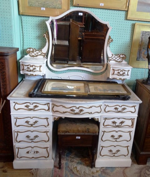 An Edwardian, French-style white and gilt painted dressing chest, the adjustable shield shape mirror