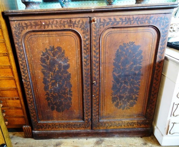 A Victorian pine utility cupboard, the rectangular top over a pair of stencil decorated panelled