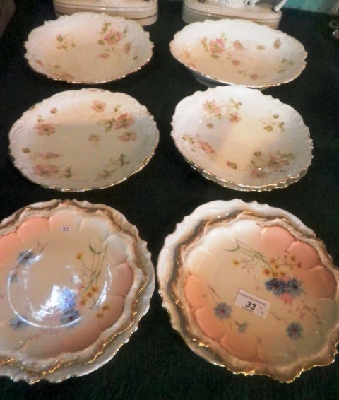 A Continental porcelain eight piece dessert service, each transfer decorated with trailing pink and