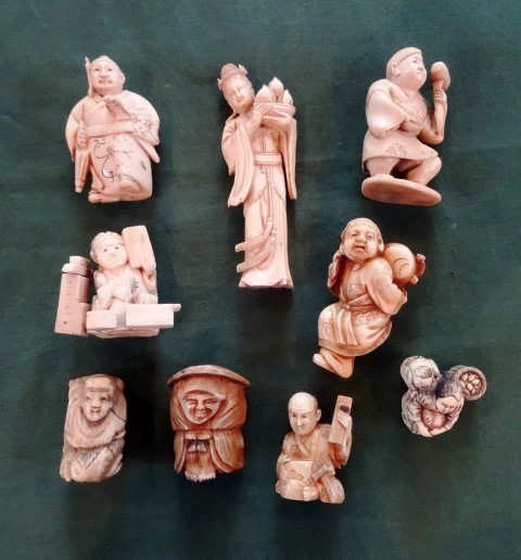A collection of eight Japanese bone and ivory netsuke, variously figurally modelled, together with