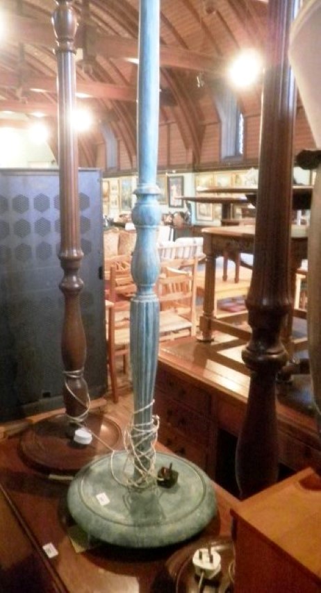 A pair of mahogany stained standard lamps, together with another, distressed green painted