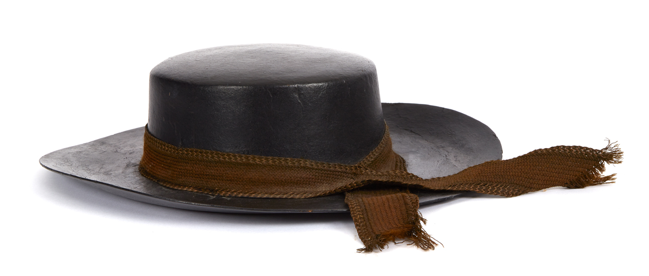 AN EARLY 19TH-CENTURY SAILOR`S FOUL WEATHER HAT constructed from tarred leather with stitched brim