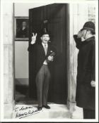Norman Wisdom signed 10x8 b/w photo. Superb shot of him at No. 10 Downing Street. Good condition
