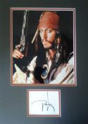 Johnny Depp signed page matted to 28cm x 40cm with nice 10 x 8 colour photo as Jack Sparrow. Good