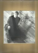 Elton John signed 1 0x 8 b/w photo mounted to 12 x 8 overall. Good condition