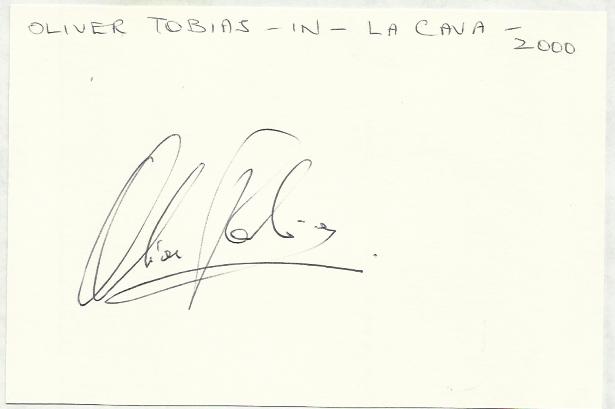 Oliver Tobias signed large 6 x 4 white card lightly fixed to A4 white page.