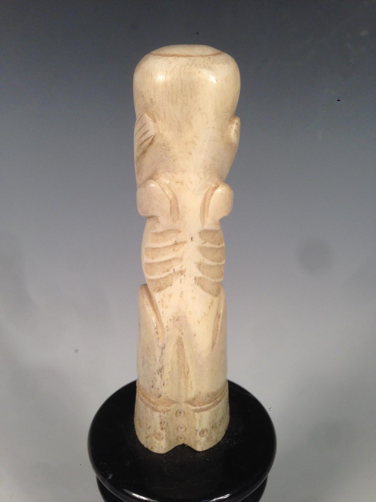 A New Zealand bone teko teko carved as a female, the naked stylised figure seated holding her hands - Image 4 of 4