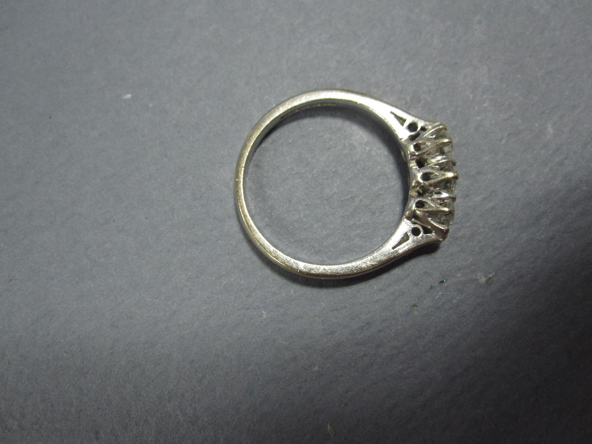 A three stone diamond ring set in 18ct white gold, the three uniform round brilliant cut diamonds - Image 2 of 4