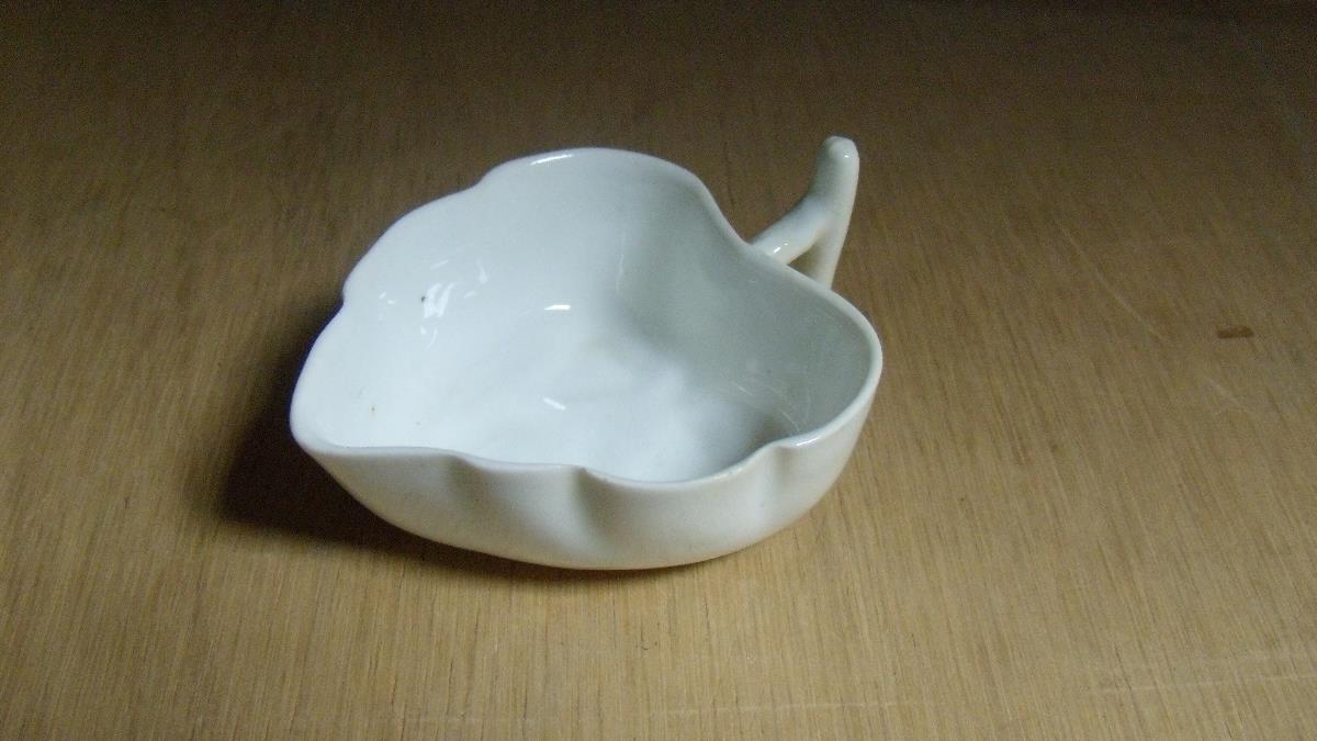 A Lowestoft white glazed butter boat, the stem handle to the leaf shape ending in three further