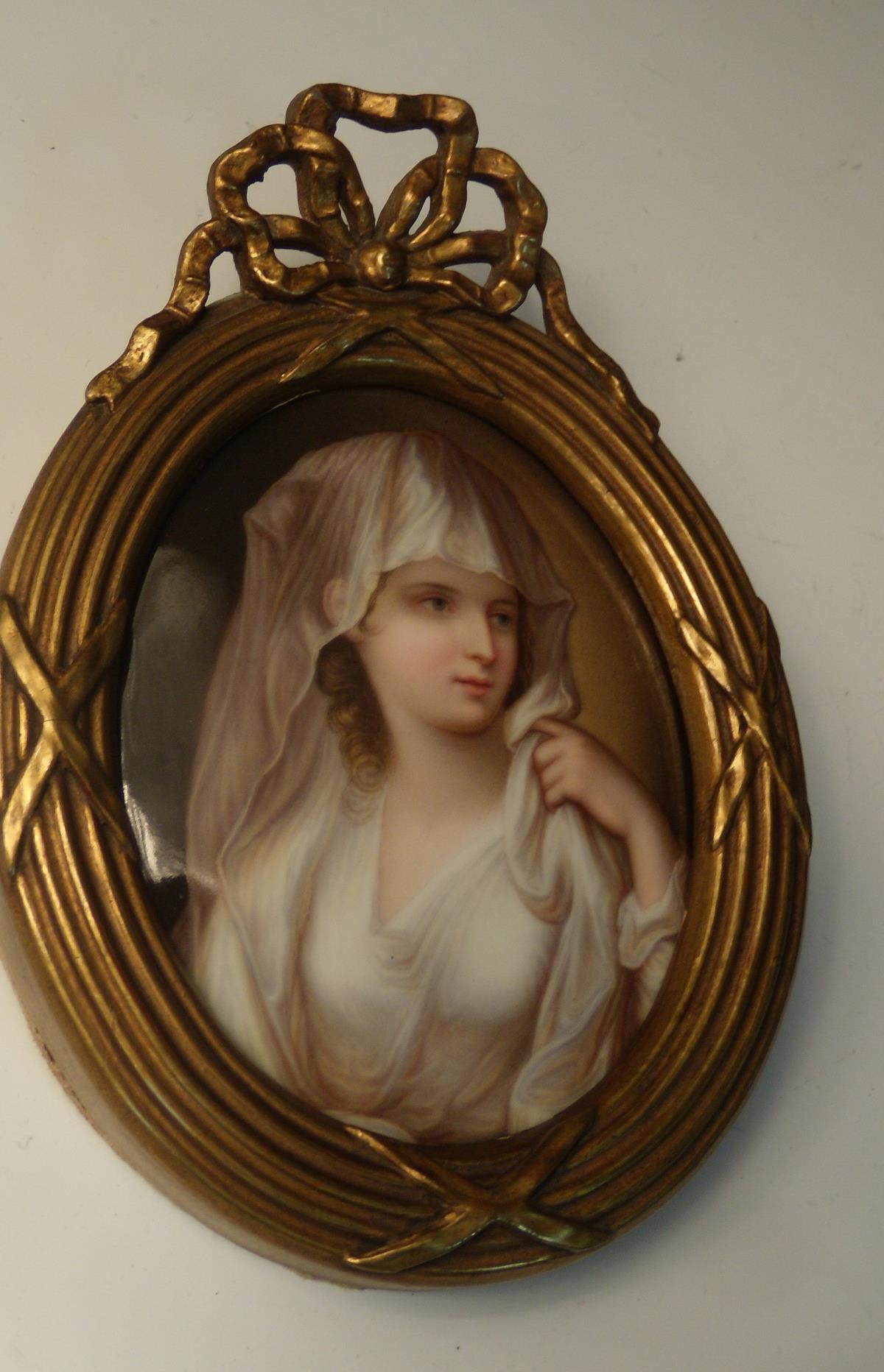 A 19th century German porcelain oval plaque painted with a vestal virgin after Angelica Kauffman,