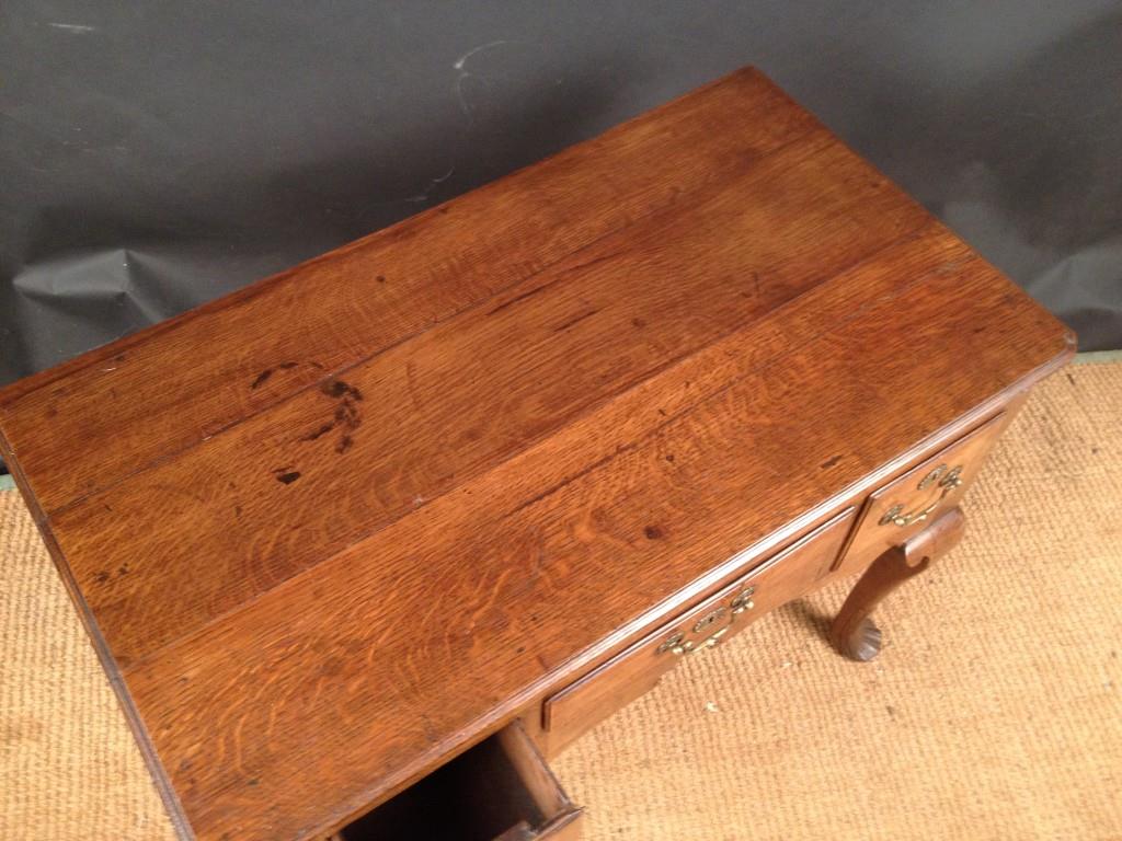 An 18th century oak Low boy, with re-entrant corners, three small drawers, on cabriole legs and - Image 4 of 5