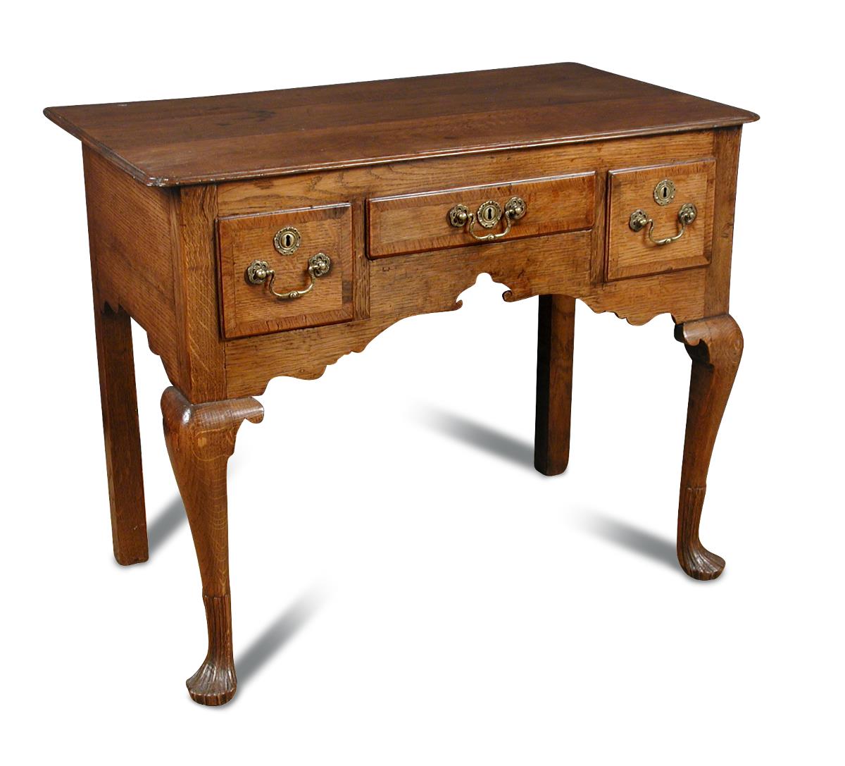 An 18th century oak Low boy, with re-entrant corners, three small drawers, on cabriole legs and
