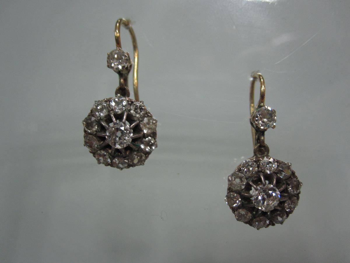 A pair of Victorian diamond cluster earpendants, each wire hook with safety catch, and claw set to