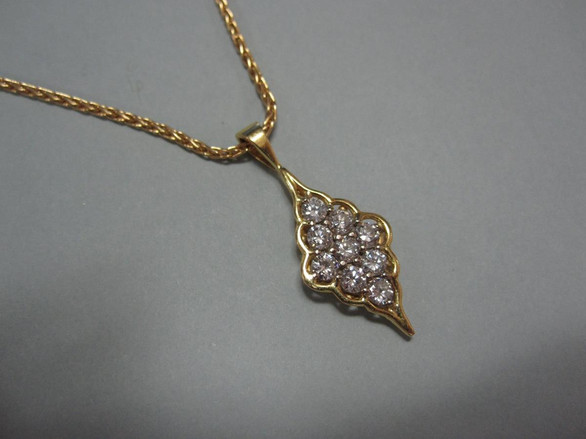 A modern diamond and 18ct gold pendant and chain, the pendant of scallop-edged diaper form set - Image 4 of 4