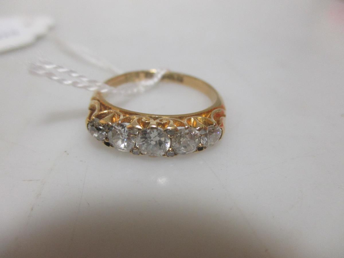 An Edwardian five stone diamond ring set in 18ct gold, the graduated old round to cushion cut