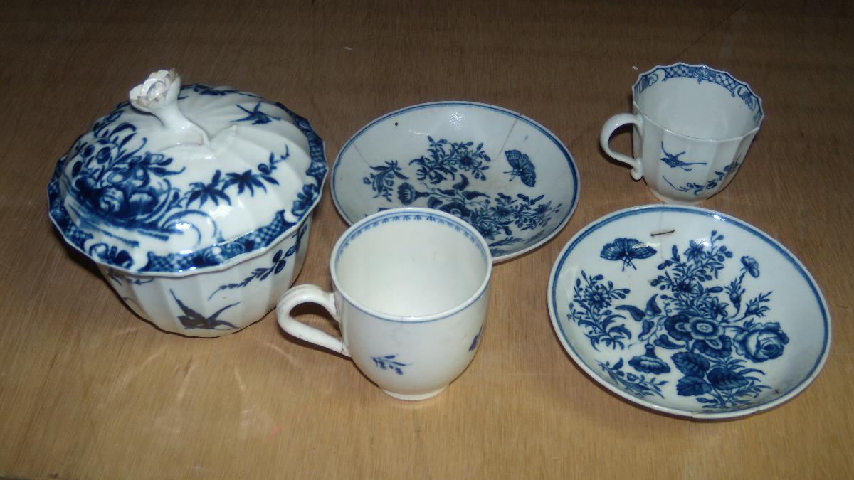 An 18th century Worcester blue and white sucrier and cover, two saucers and two coffee cups, each