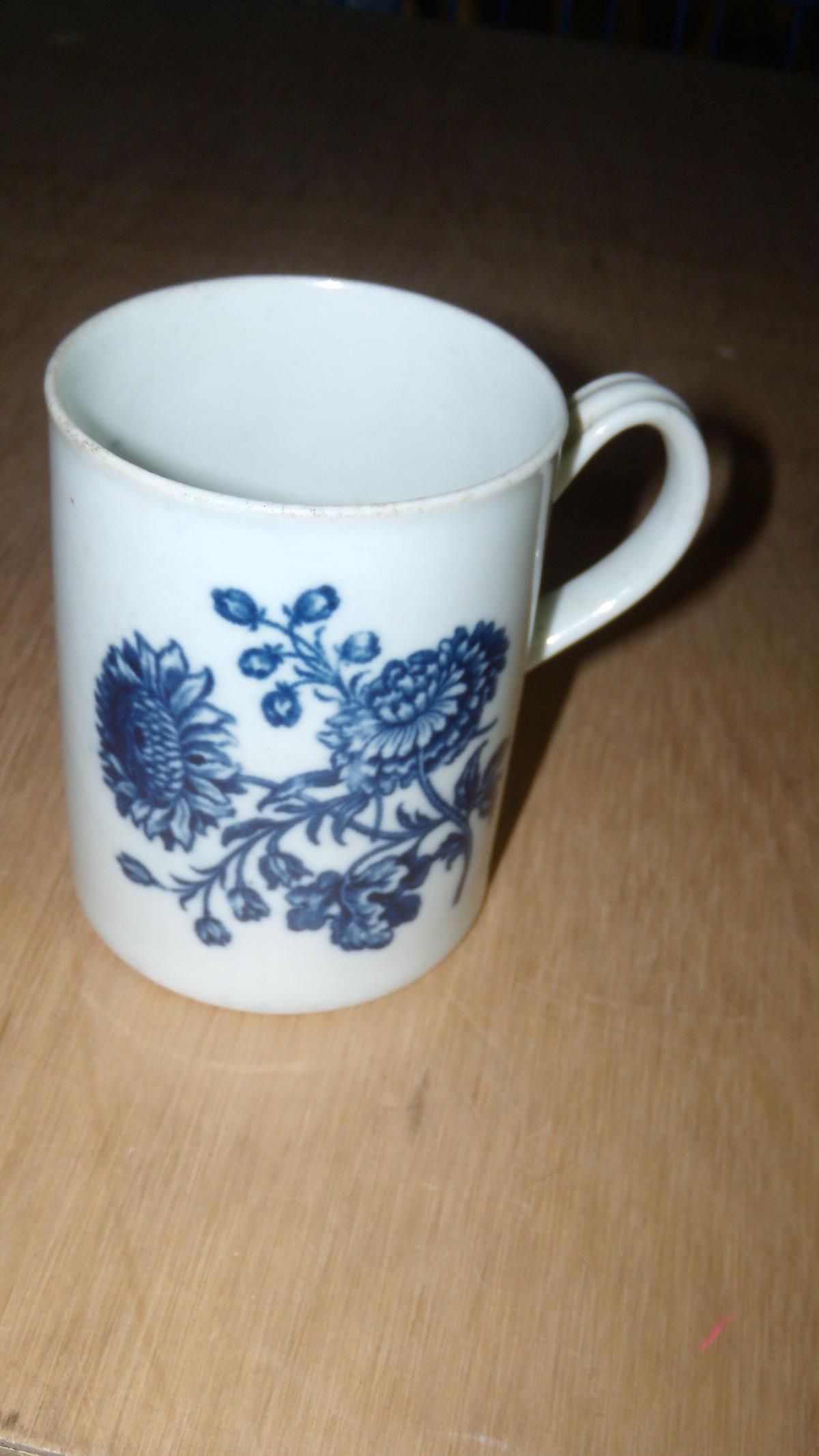 An 18th century Worcester blue and white mug, the cylindrical sides printed with bunches of