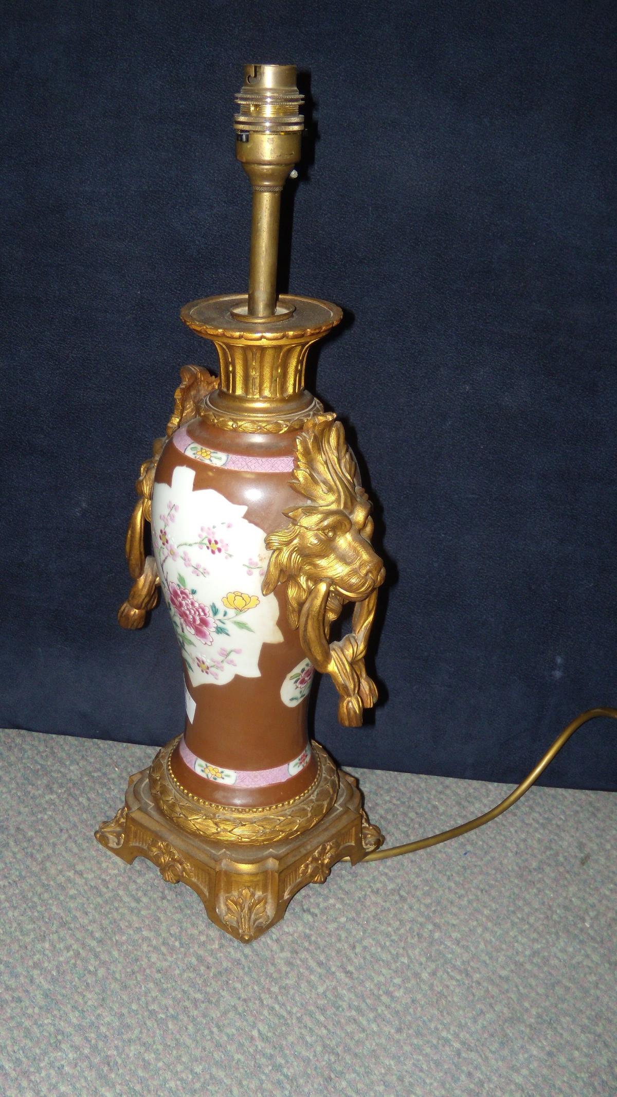 An 18th century Chinese famille rose vase ormolu mounted as a table lamp, the sides of the baluster