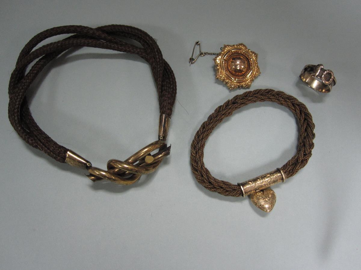 Two 19th century hairwork bracelets together with two other items of Victorian memento jewellery,