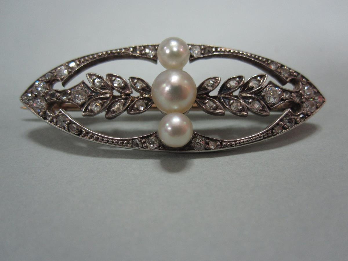 A belle époque pearl and diamond brooch of open navette form, of beaded and diamond set outline,