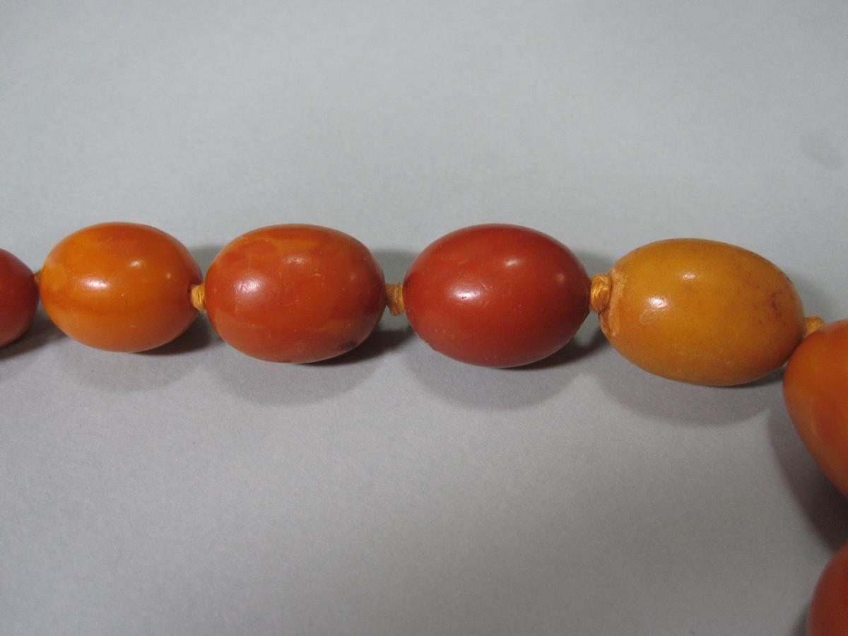 A vintage butterscotch amber bead necklace and another, the first of graduated 15-23mm long oval - Image 3 of 8