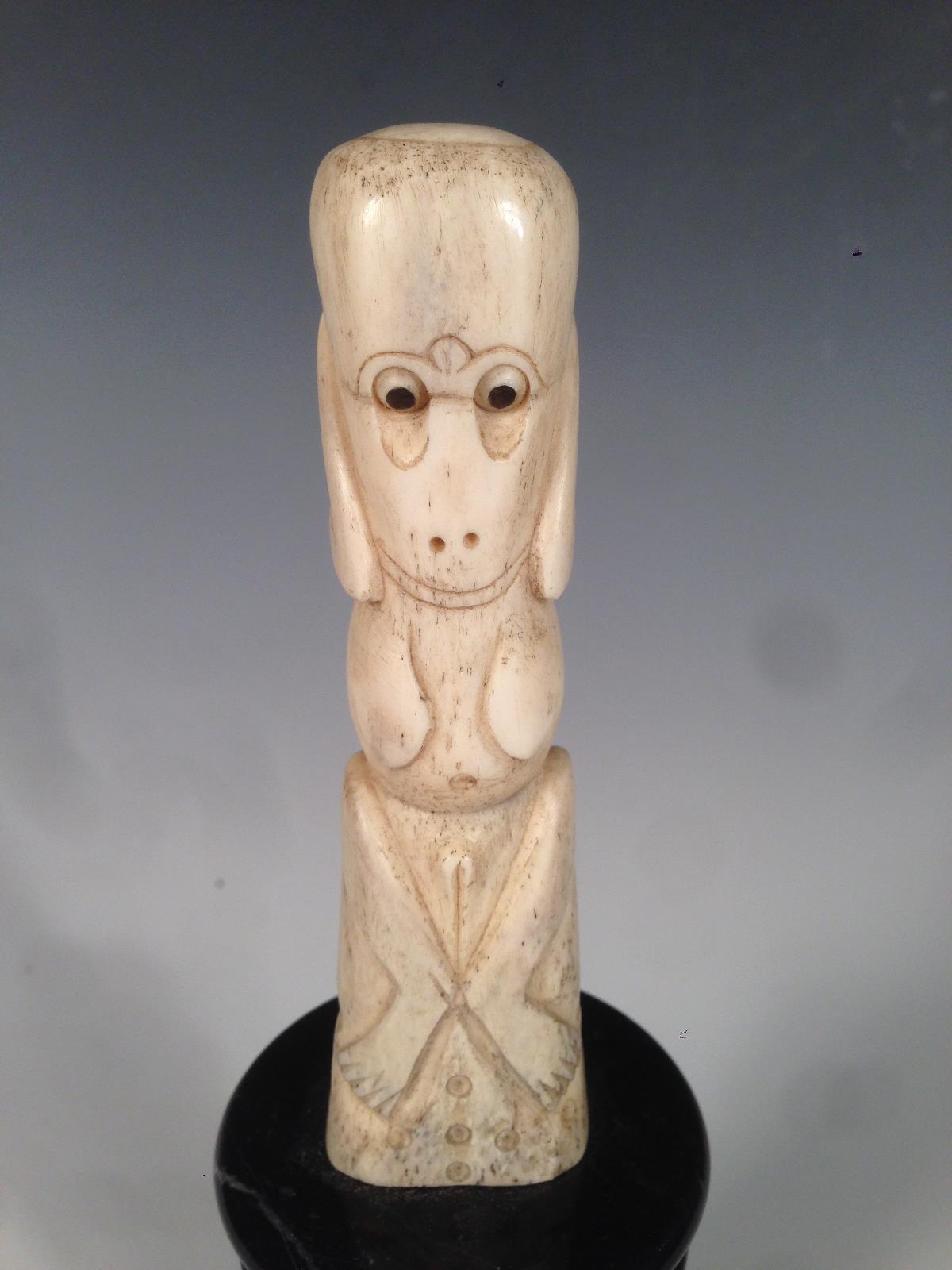 A New Zealand bone teko teko carved as a female, the naked stylised figure seated holding her hands - Image 2 of 4