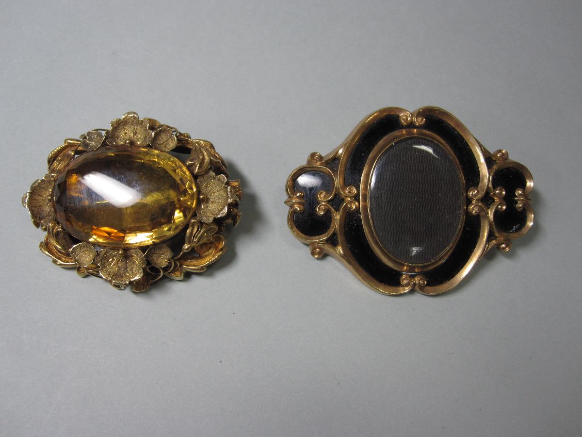 Two bold Victorian brooches, the first with a large oval cut light gold citrine in a pierced,