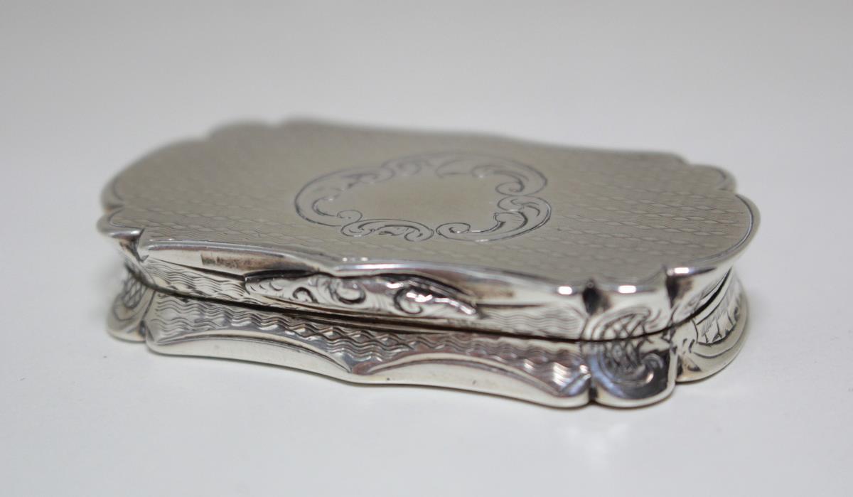 A large Victorian silver vinaigrette by Alfred Taylor, Birmingham 1853, of serpentine form, engine