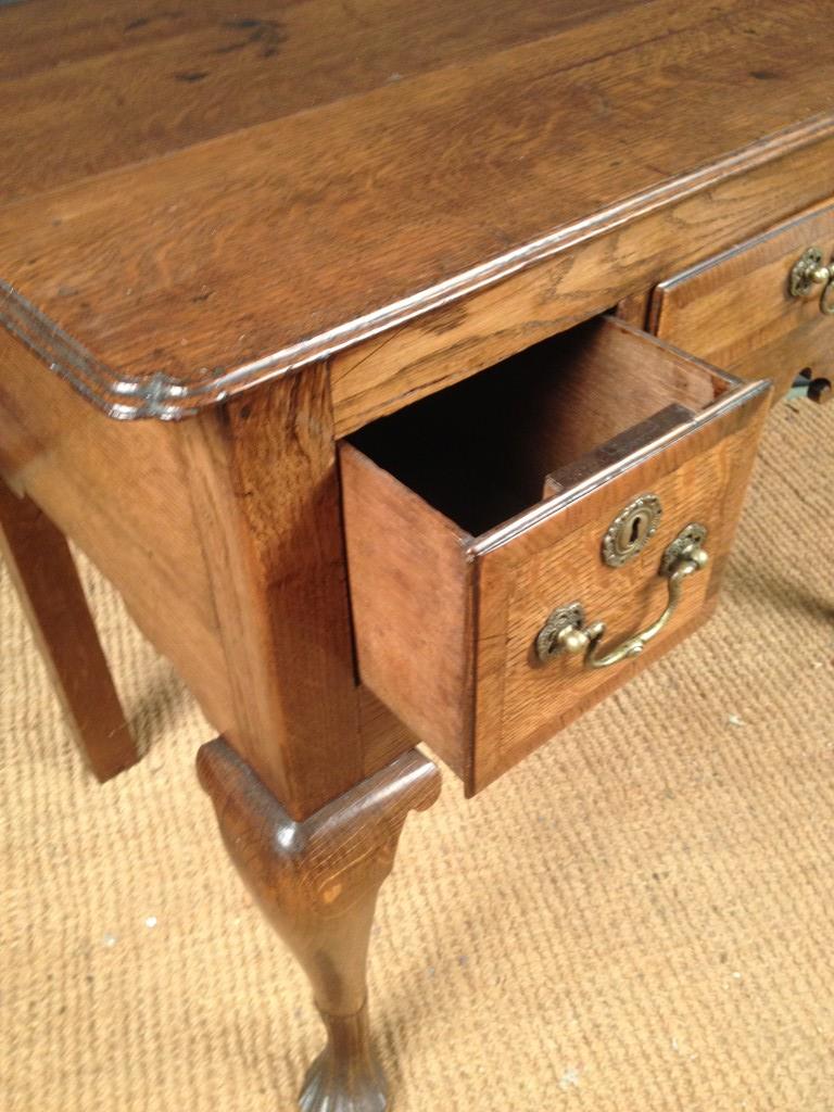 An 18th century oak Low boy, with re-entrant corners, three small drawers, on cabriole legs and - Image 3 of 5