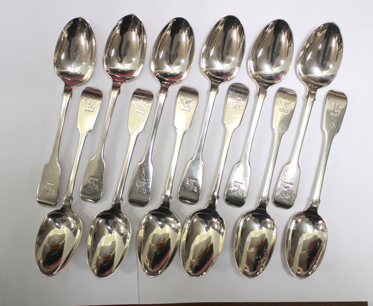 A matched set of twelve Irish fiddle pattern dessert spoons, eleven by Peter Walsh or Philip