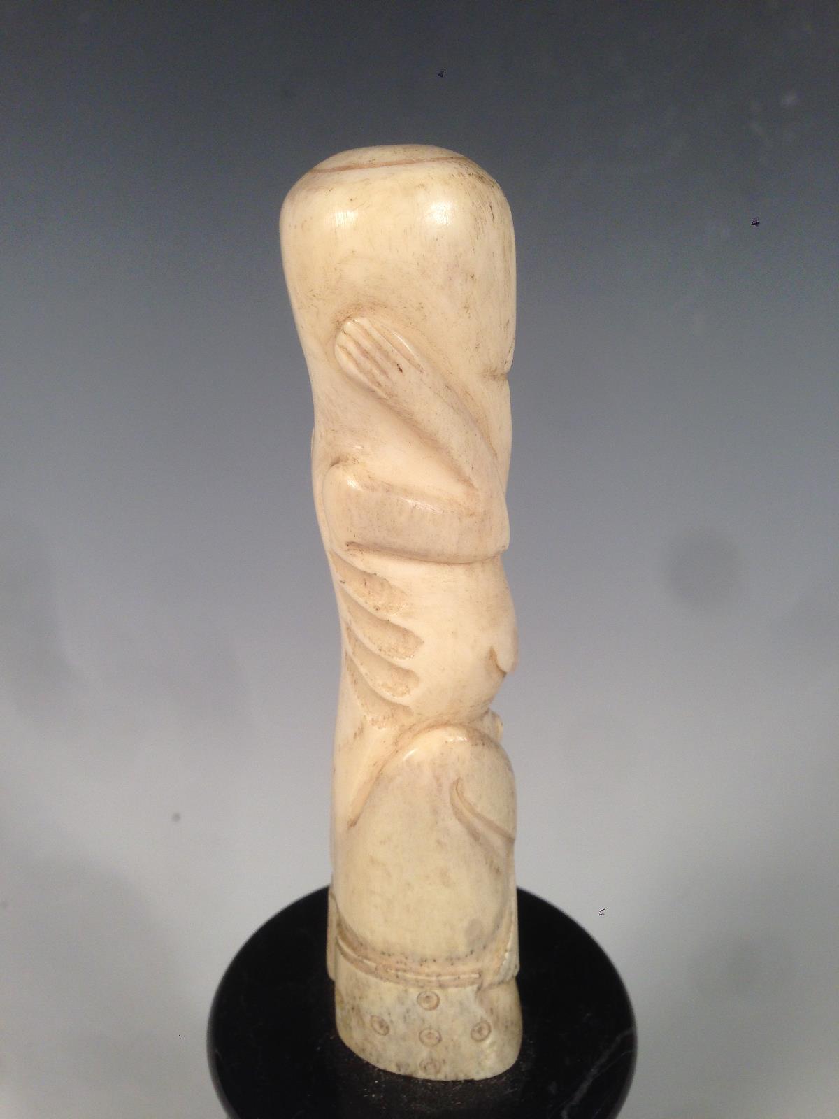 A New Zealand bone teko teko carved as a female, the naked stylised figure seated holding her hands - Image 3 of 4