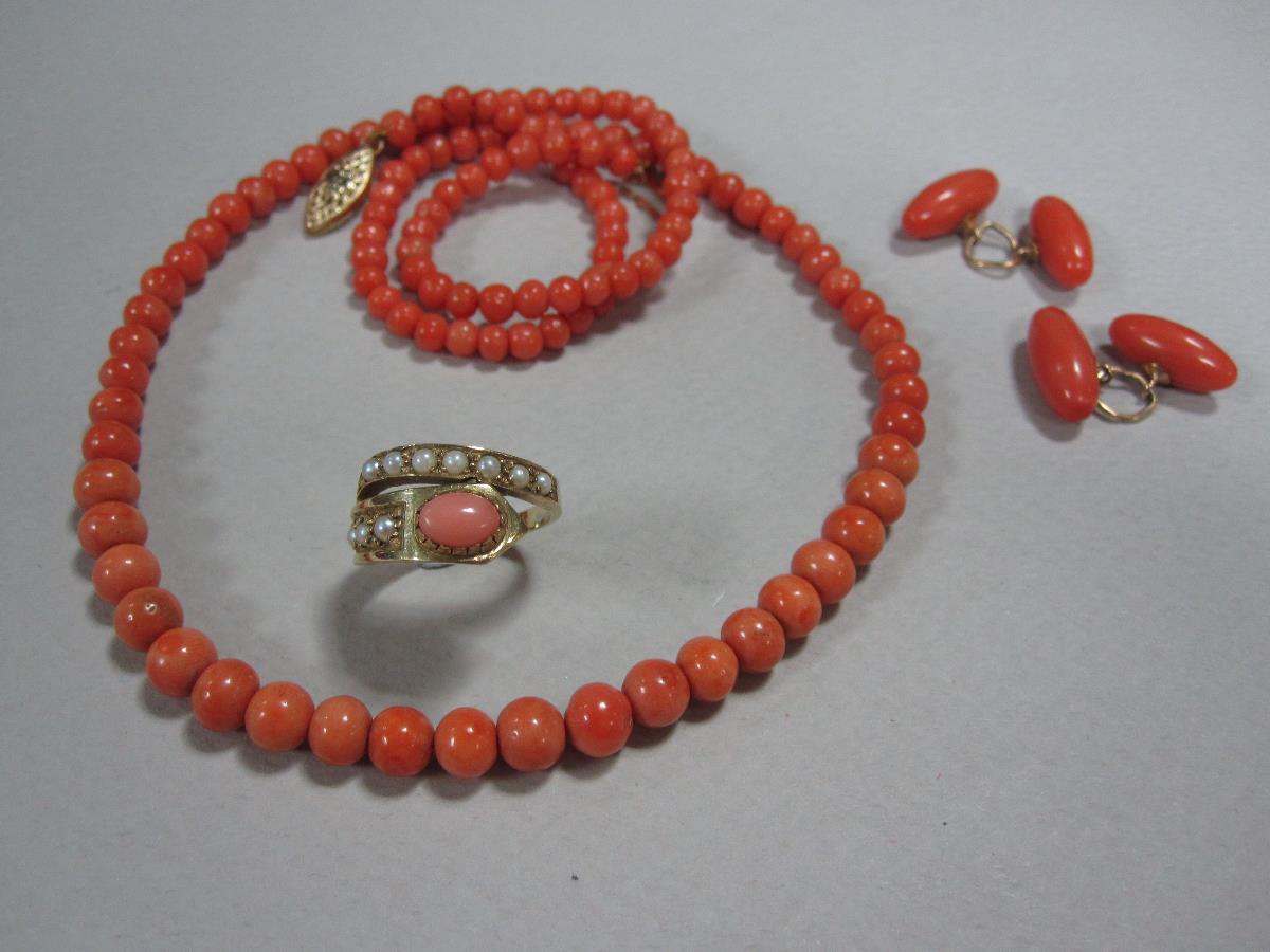 A small collection of coral jewellery, firstly a 9ct gold coral and seed pearl ring of asymmetric