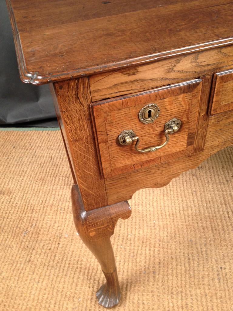An 18th century oak Low boy, with re-entrant corners, three small drawers, on cabriole legs and - Image 2 of 5
