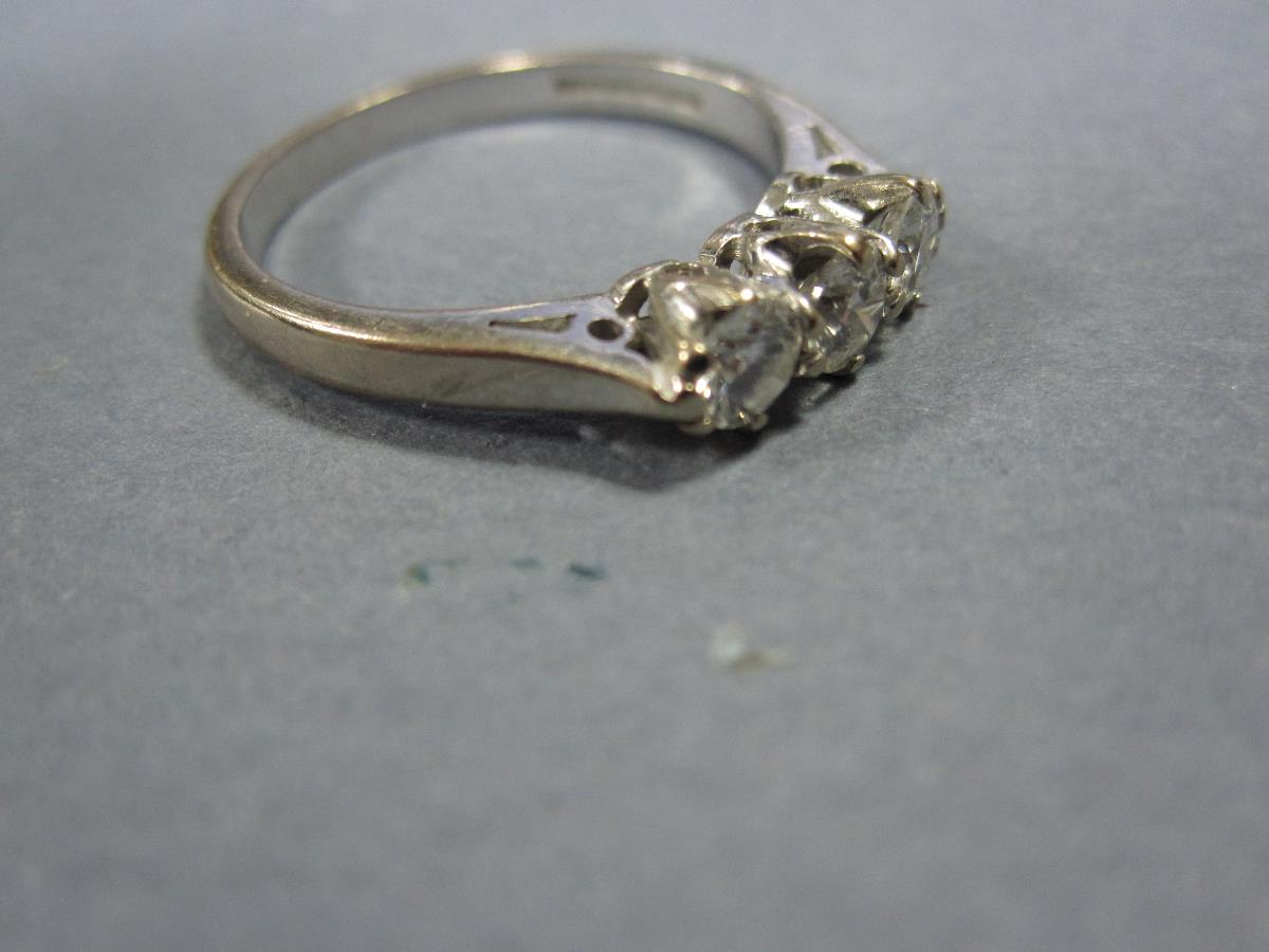 A three stone diamond ring set in 18ct white gold, the three uniform round brilliant cut diamonds - Image 3 of 4