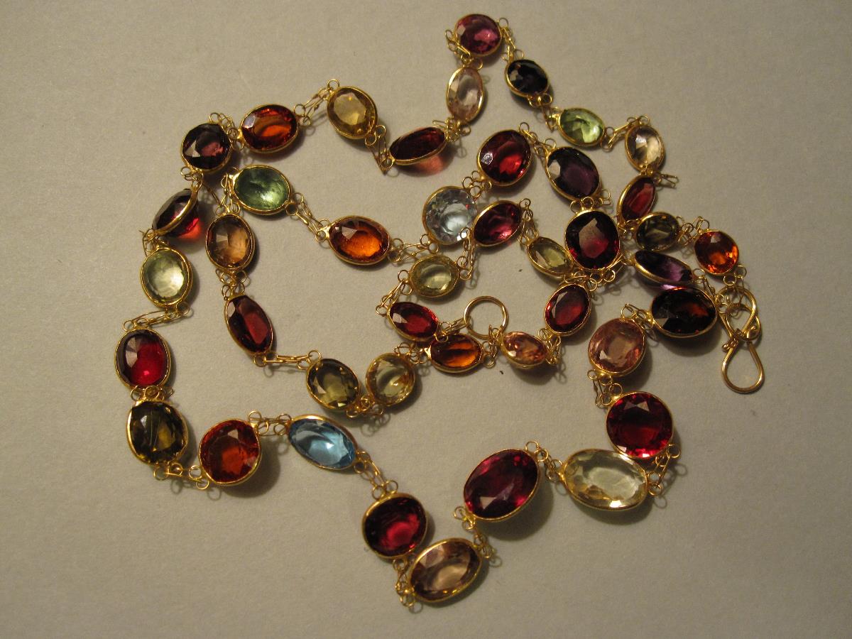 A multi-gemset necklace, designed as a fine chain set all along with gently graduated oval and