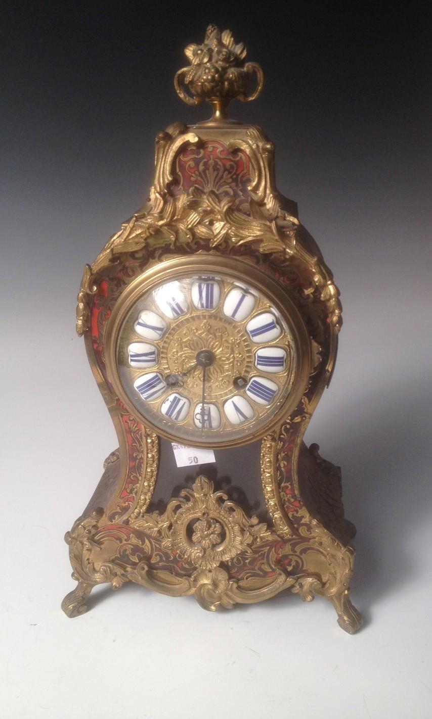 A French late 19th century `Boulle` mantel clock, the tortoiseshell and gilt metal mounted waisted
