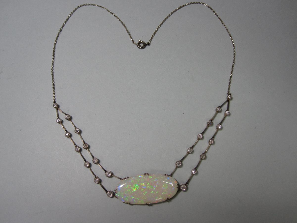A late 19th century opal and diamond necklace in period fitted case, set with a large, fine oval