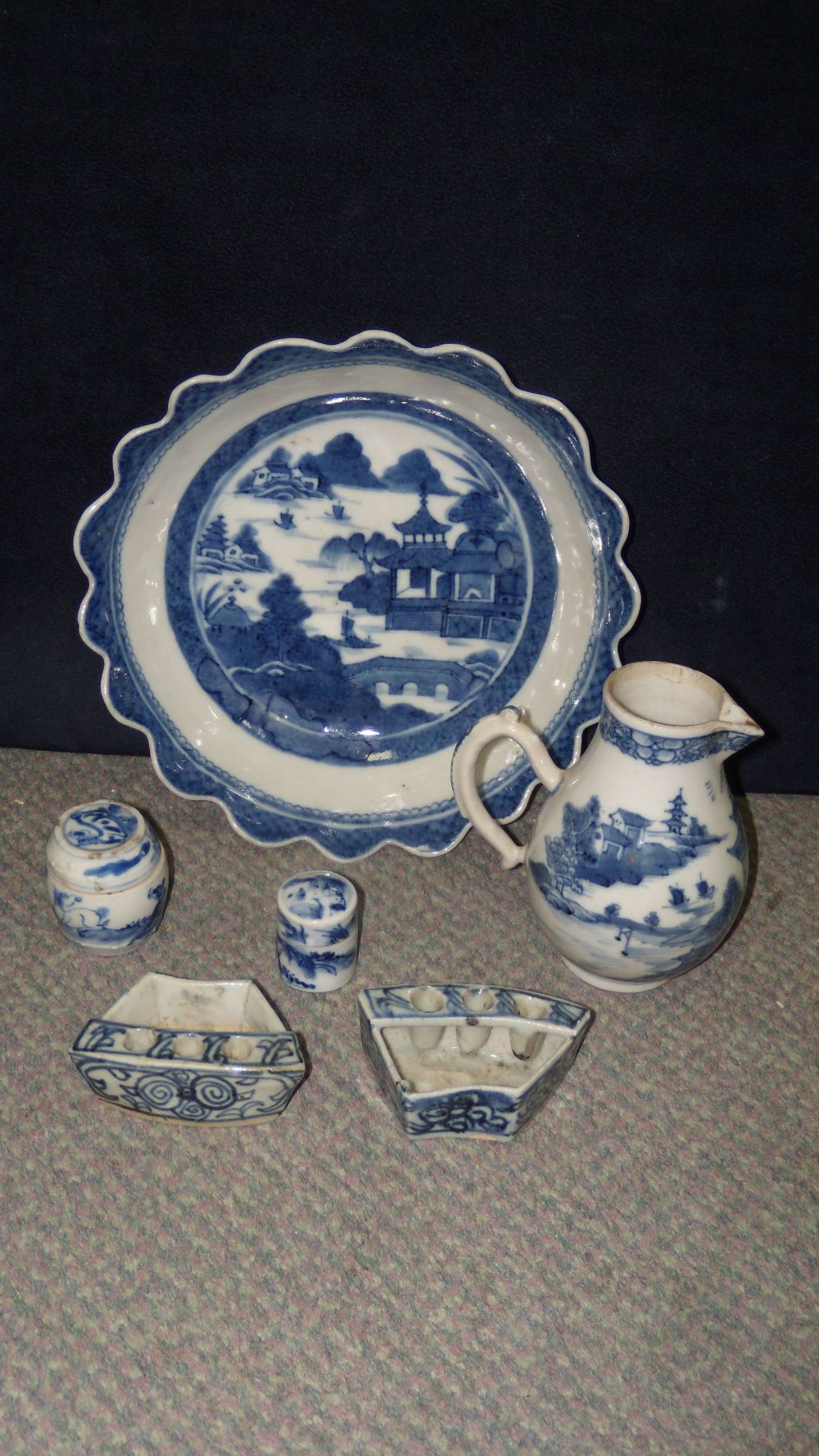 A collection of 18th and 19th century blue and white wares, the jug and the bowl painted with