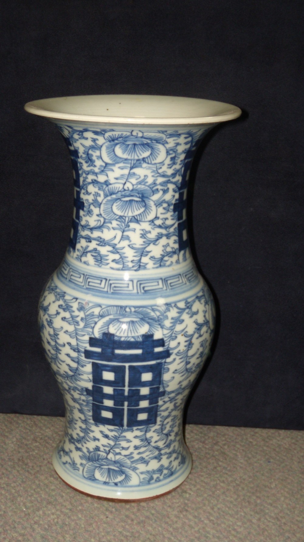 A late 19th/early 20th century blue and white vase, the pairs of shou characters on the waisted