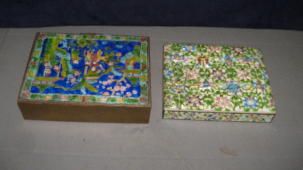 Two 20th century enamel boxes, the rectangular lid of the first moulded in relief and painted with