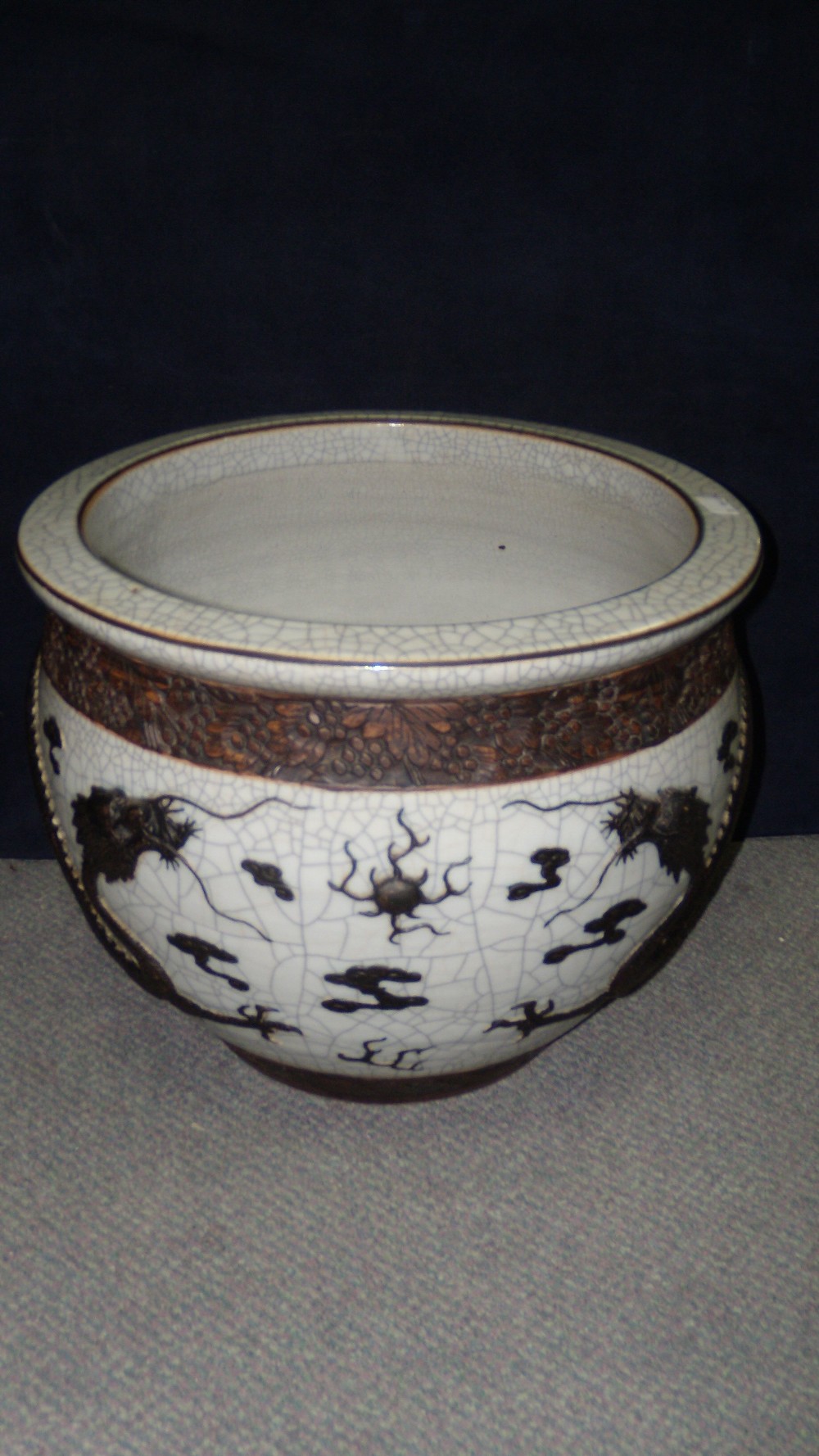 A late 19th/early 20th century crackleware planter, the rounded sides with a bronzed dragon in