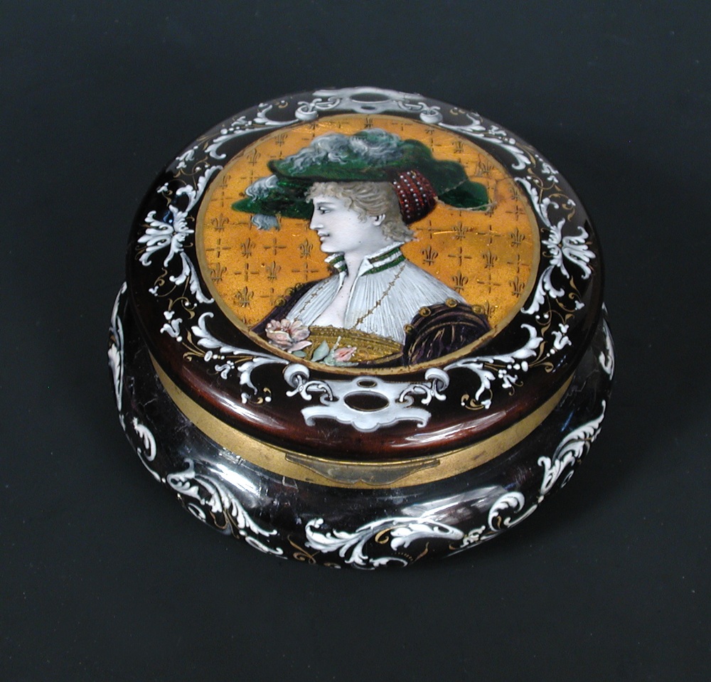A late 19th century Limoges enamel box, 14.5cm (5.75 in) diameter There is a chip glued back at the